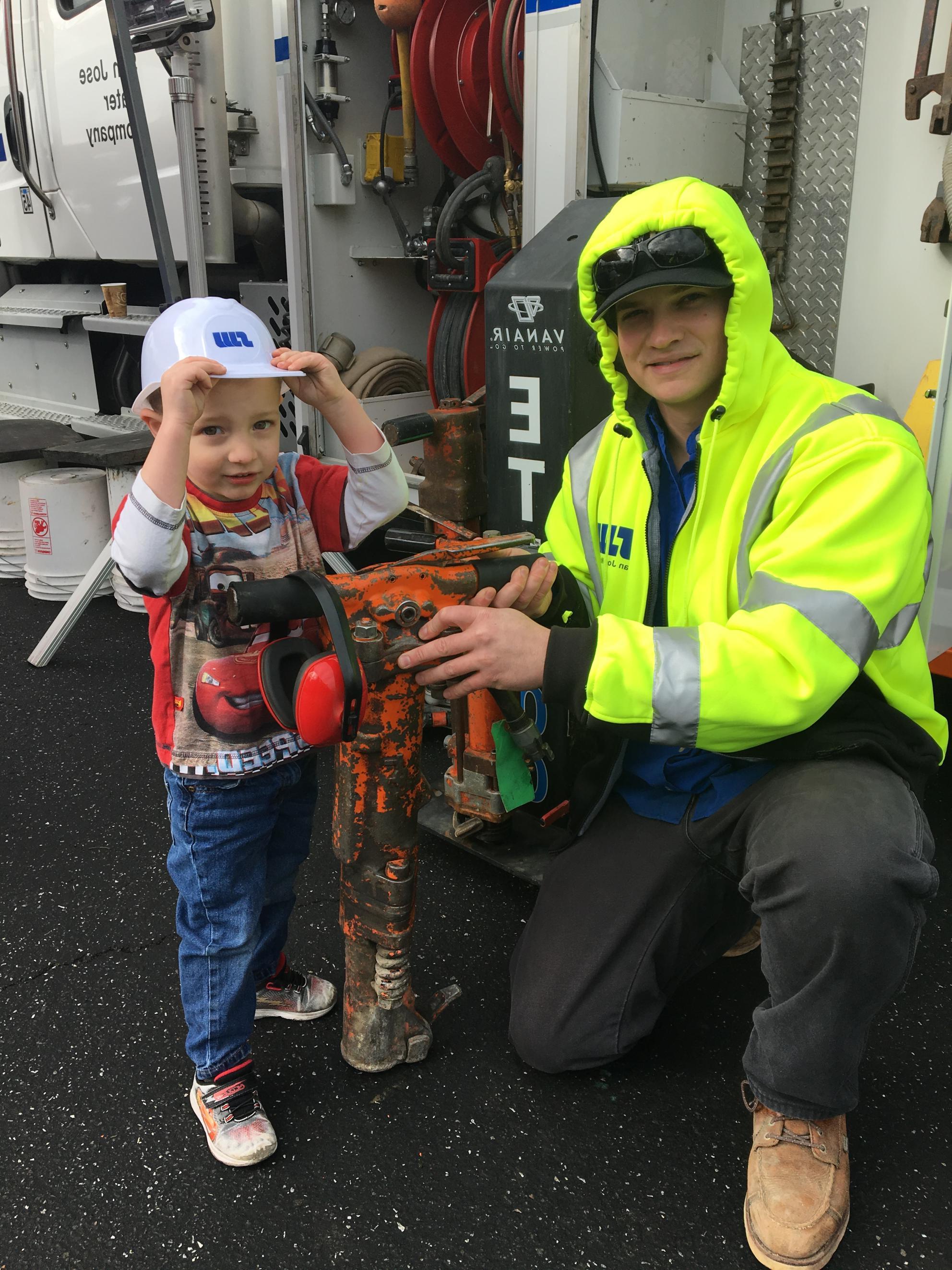 SJW Staff and child at Touch a Truck event